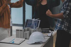 Electrical engineer with businessman discussing new project installation solar cell panel on the roof of building. Alternative energy concept. photo