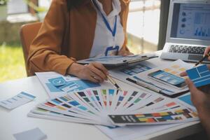 Close up ux developer and ui designer use augmented reality brainstorming about mobile app interface wireframe design on desk at modern office.Creative digital development agency photo