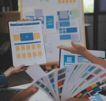 Close up ux developer and ui designer use augmented reality brainstorming about mobile app interface wireframe design on desk at modern office.Creative digital development agency photo