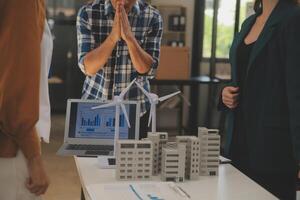 Electrical engineer with businessman discussing new project installation solar cell panel on the roof of building. Alternative energy concept. photo