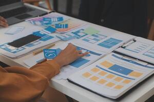 Close up ux developer and ui designer use augmented reality brainstorming about mobile app interface wireframe design on desk at modern office.Creative digital development agency photo