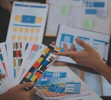 Close up ux developer and ui designer use augmented reality brainstorming about mobile app interface wireframe design on desk at modern office.Creative digital development agency photo