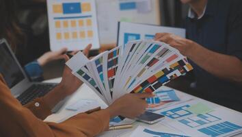 Close up ux developer and ui designer use augmented reality brainstorming about mobile app interface wireframe design on desk at modern office.Creative digital development agency photo