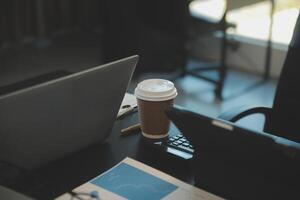 Laptop on a desk in an open financial office. photo