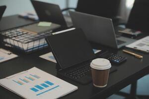 Laptop on a desk in an open financial office. photo