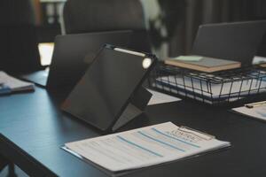Laptop on a desk in an open financial office. photo