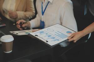 Business team meeting present, investor colleagues consultation and conference new strategy plan business and market growth on financial document graph report, Meeting and Talking. photo