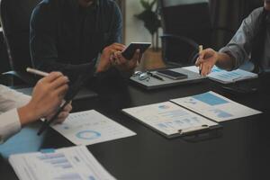 Business team collaboration discussing working analyzing with financial data and marketing growth report graph in team, presentation and brainstorming to strategy planning making profit of company. photo