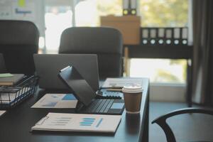 Laptop on a desk in an open financial office. photo