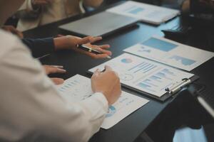 Business team collaboration discussing working analyzing with financial data and marketing growth report graph in team, presentation and brainstorming to strategy planning making profit of company. photo