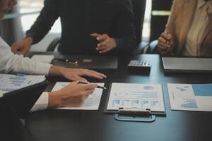 Business team collaboration discussing working analyzing with financial data and marketing growth report graph in team, presentation and brainstorming to strategy planning making profit of company. photo