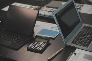 Laptop on a desk in an open financial office. photo