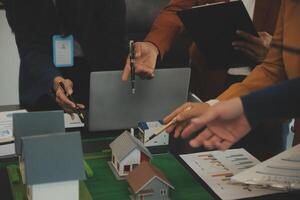 Team of architectures and businessmen discussing and brainstorming on floor plan modification for real estate investment and housing development project photo