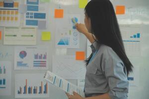 Business team collaboration discussing working analyzing with financial data and marketing growth report graph in team, presentation and brainstorming to strategy planning making profit of company. photo