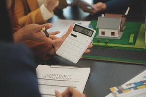 Team of architectures and businessmen discussing and brainstorming on floor plan modification for real estate investment and housing development project photo