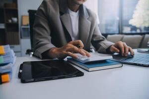 Business team working with new startup project plan and discussion information for financial strategy with laptop and digital tablet in a modern business lounge. photo