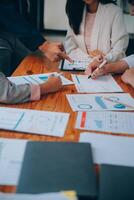 Business team working with new startup project plan and discussion information for financial strategy with laptop and digital tablet in a modern business lounge. photo