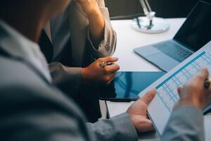 Close up of Business team analyzing income charts and graphs with modern laptop computer. Business analysis and strategy concept. photo