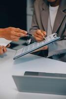 Business team working with new startup project plan and discussion information for financial strategy with laptop and digital tablet in a modern business lounge. photo
