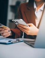 Hands holding plastic credit card and using laptop. Online shopping concept. Toned picture photo