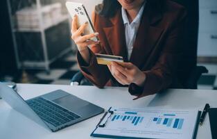 Hands holding plastic credit card and using laptop. Online shopping concept. Toned picture photo