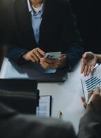 Business team working with new startup project plan and discussion information for financial strategy with laptop and digital tablet in a modern business lounge. photo