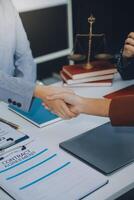 Businessman shaking hands to seal a deal with his partner lawyers or attorneys discussing a contract agreement. photo