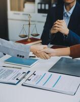 Businessman shaking hands to seal a deal with his partner lawyers or attorneys discussing a contract agreement. photo