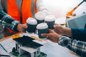 Image of engineer meeting for architectural project. working with partner and engineering tools on workplace vintage tone. photo