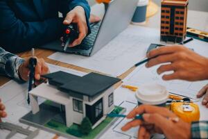 Image of engineer meeting for architectural project. working with partner and engineering tools on workplace vintage tone. photo