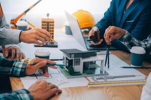 Image of engineer meeting for architectural project. working with partner and engineering tools on workplace vintage tone. photo