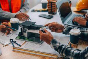 Image of engineer meeting for architectural project. working with partner and engineering tools on workplace vintage tone. photo