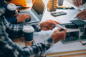 Image of engineer meeting for architectural project. working with partner and engineering tools on workplace vintage tone. photo