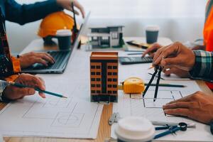 Image of engineer meeting for architectural project. working with partner and engineering tools on workplace vintage tone. photo