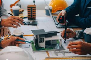 Image of engineer meeting for architectural project. working with partner and engineering tools on workplace vintage tone. photo
