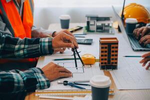 Image of engineer meeting for architectural project. working with partner and engineering tools on workplace vintage tone. photo