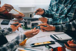 engineer people meeting working and pointing at a drawings in office for discussing. Engineering tools and construction concept. photo