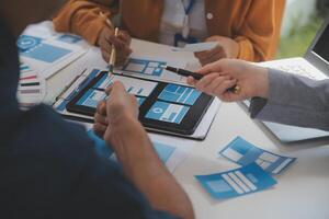 Close up ux developer and ui designer use augmented reality brainstorming about mobile app interface wireframe design on desk at modern office.Creative digital development agency photo
