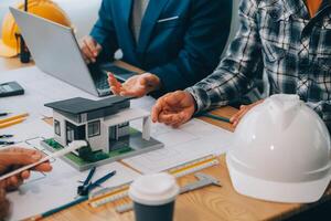 Image of engineer meeting for architectural project. working with partner and engineering tools on workplace vintage tone. photo