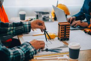 Image of engineer meeting for architectural project. working with partner and engineering tools on workplace vintage tone. photo