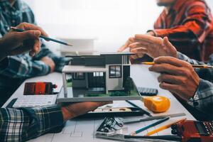 engineer people meeting working and pointing at a drawings in office for discussing. Engineering tools and construction concept. photo