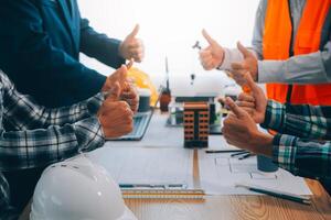 imagen de ingeniero reunión para arquitectónico proyecto. trabajando con compañero y Ingenieria herramientas en lugar de trabajo Clásico tono. foto