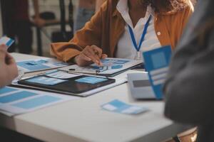 Close up ux developer and ui designer use augmented reality brainstorming about mobile app interface wireframe design on desk at modern office.Creative digital development agency photo