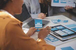 Close up ux developer and ui designer use augmented reality brainstorming about mobile app interface wireframe design on desk at modern office.Creative digital development agency photo