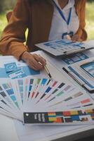 Close up ux developer and ui designer use augmented reality brainstorming about mobile app interface wireframe design on desk at modern office.Creative digital development agency photo