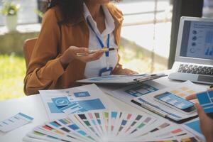 Close up ux developer and ui designer use augmented reality brainstorming about mobile app interface wireframe design on desk at modern office.Creative digital development agency photo
