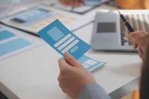 Close up ux developer and ui designer use augmented reality brainstorming about mobile app interface wireframe design on desk at modern office.Creative digital development agency photo