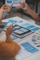 Close up ux developer and ui designer use augmented reality brainstorming about mobile app interface wireframe design on desk at modern office.Creative digital development agency photo