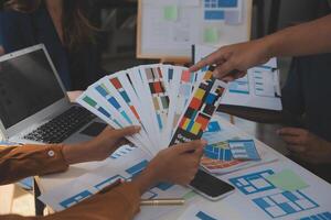 Close up ux developer and ui designer use augmented reality brainstorming about mobile app interface wireframe design on desk at modern office.Creative digital development agency photo