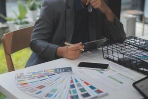 Close up ux developer and ui designer use augmented reality brainstorming about mobile app interface wireframe design on desk at modern office.Creative digital development agency photo